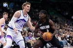Utah Jazz forward Lauri Markkanen, left, defends Portland Trail Blazers guard Jrue Holiday (5) during the first half of an NBA basketball game, Wednesday, Oct. 29, 2025, in Salt Lake City.