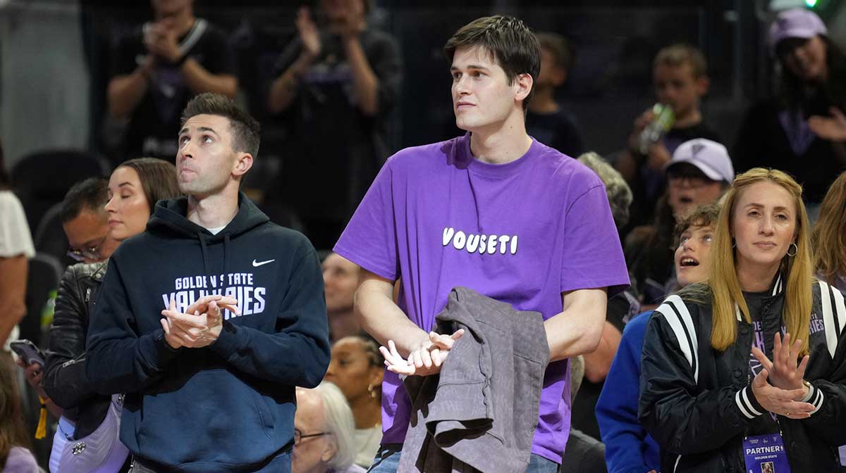 Golden State Warriors 2025 draft pick Alex Toohey (center) stands on the court after the game between the Golden State Valkyries and the Seattle Storm at Chase Center.