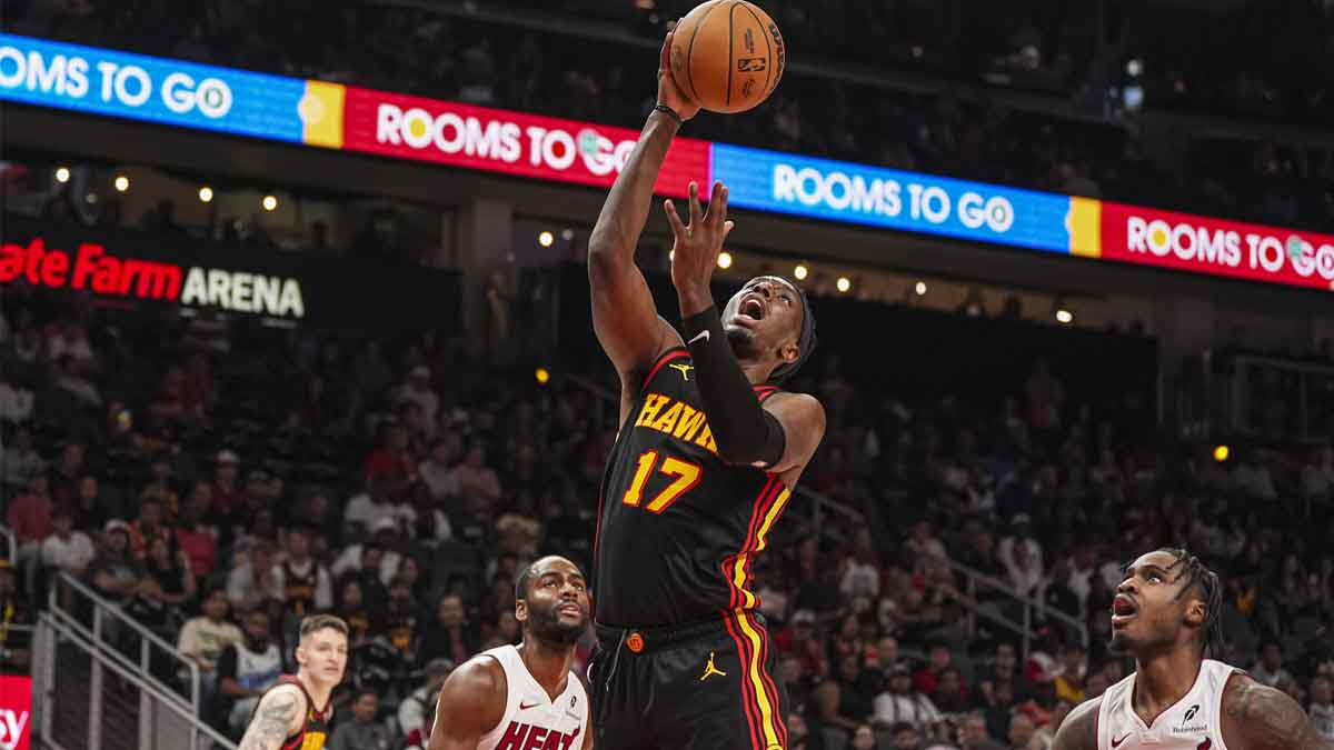 Atlanta Hawks forward Onyeka Okongwu (17) shoots at the basket behind Miami Heat guard Davion Mitchell (45) during the first half at State Farm Arena.