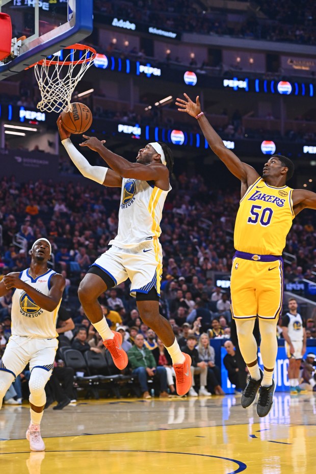 Golden State Warriors' Buddy Hield (7) goes up for a basket past Los Angeles Lakers' Nate Williams (50) in the first quarter of their preseason NBA game at Chase Center in San Francisco, Calif., on Sunday, Oct. 5, 2025. (Jose Carlos Fajardo/Bay Area News Group)
