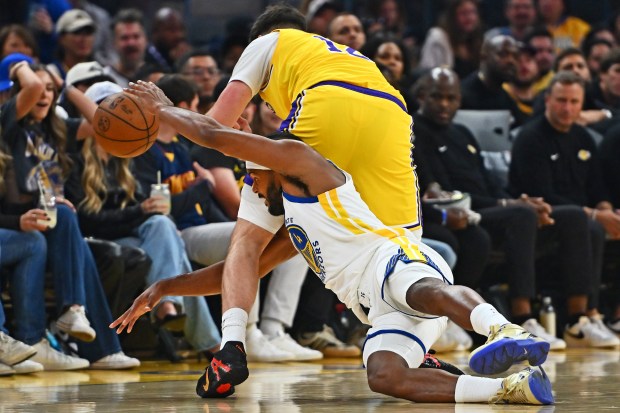 Golden State Warriors' Moses Moody (4) attempts to steal a ball from Los Angeles Lakers' Jake LaRavia (12) in the first quarter of their preseason NBA game at Chase Center in San Francisco, Calif., on Sunday, Oct. 5, 2025. (Jose Carlos Fajardo/Bay Area News Group)