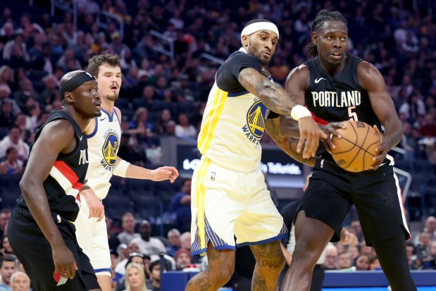 Portland Trail Blazers' Jrue Holiday (5) gains a rebound against the Golden State Warriors' Gary Payton II (0) in the second quarter of an NBA preseason game at Chase Center in San Francisco, Calif., on Wednesday, Oct. 8, 2025. (Ray Chavez/Bay Area News Group)