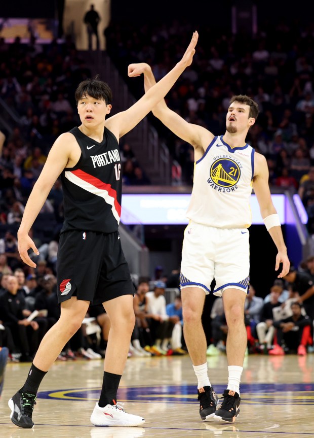 Golden State Warriors' Quinten Post (21) follows his shot against Portland Trail Blazers' Yang Hansen (16) in the second quarter of an NBA preseason game at Chase Center in San Francisco, Calif., on Wednesday, Oct. 8, 2025. (Ray Chavez/Bay Area News Group)