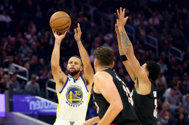 Golden State Warriors' Stephen Curry (30) lays up a three point basket and draws a foul against the Portland Trail Blazers in the first quarter of an NBA preseason game at Chase Center in San Francisco, Calif., on Wednesday, Oct. 8, 2025. (Ray Chavez/Bay Area News Group)