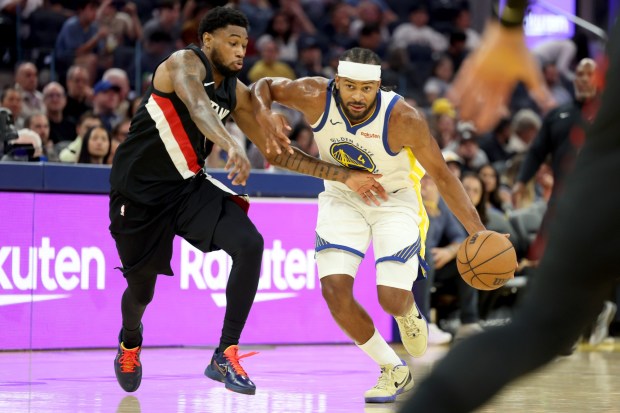 Golden State Warriors' Moses Moody (4) drives past Portland Trail Blazers' Blake Wesley (1) in the second quarter of an NBA preseason game at Chase Center in San Francisco, Calif., on Wednesday, Oct. 8, 2025. (Ray Chavez/Bay Area News Group)