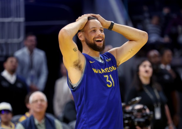 Golden State Warriors' Stephen Curry #30 reacts as his teammates...