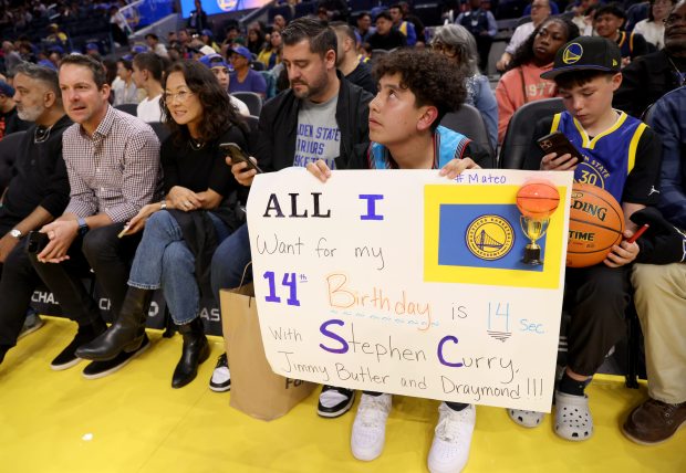 Golden State Warriors fan Matteo Pourghadir, 14, of Santa Rosa,...