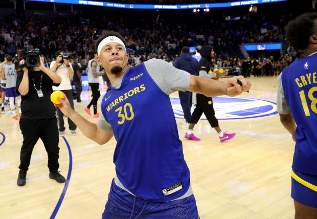 Golden State Warriors' Seth Curry #30 tosses an autographed ball...