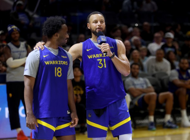Golden State Warriors' Stephen Curry #31 talks with rookie LJ...