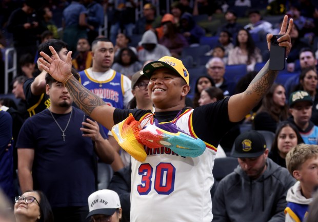 Golden State Warriors fan D.J. Magbag, of San Jose, reacts...