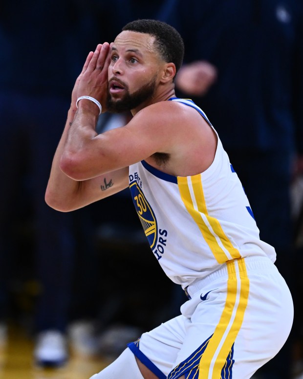 Golden State Warriors' Stephen Curry (30) gestures night night after teammate Jimmy Butler III (10) makes a 3-point basket during overtime of their NBA game at Chase Center in San Francisco, Calif., on Thursday, Oct. 23, 2025. The Golden State Warriors defeated the Denver Nuggets in overtime 137-131. (Jose Carlos Fajardo/Bay Area News Group)