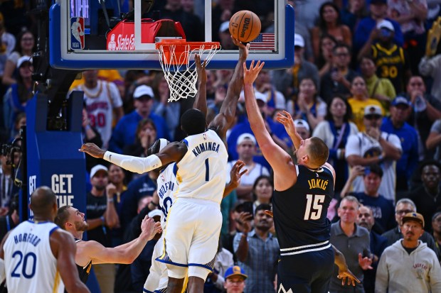 Golden State Warriors' Jonathan Kuminga (1) blocks a shot by Denver Nuggets' Nikola Jokić (15) in the fourth quarter of their NBA game at Chase Center in San Francisco, Calif., on Thursday, Oct. 23, 2025. The Golden State Warriors defeated the Denver Nuggets in overtime 137-131. (Jose Carlos Fajardo/Bay Area News Group)