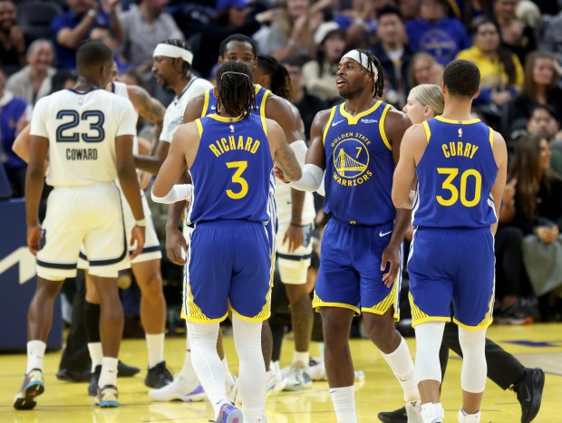 Golden State Warriors' Buddy Hield #7 is congratulated by teammates...