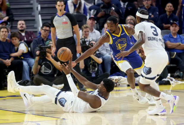 Memphis Grizzlies' Jaren Jackson Jr. #8 passes as he’s guarded...