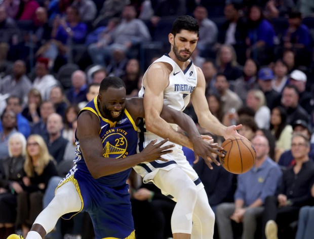 Golden State Warriors' Draymond Green #23 battles Memphis Grizzlies' Santi...