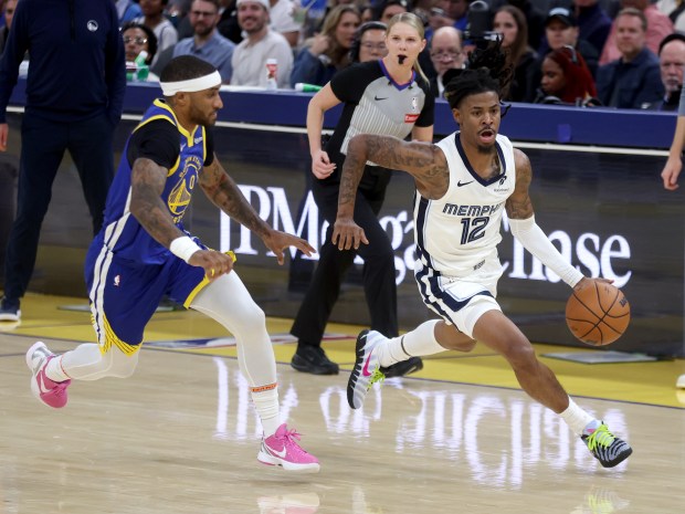 Memphis Grizzlies' Ja Morant #12 brings the ball down court...