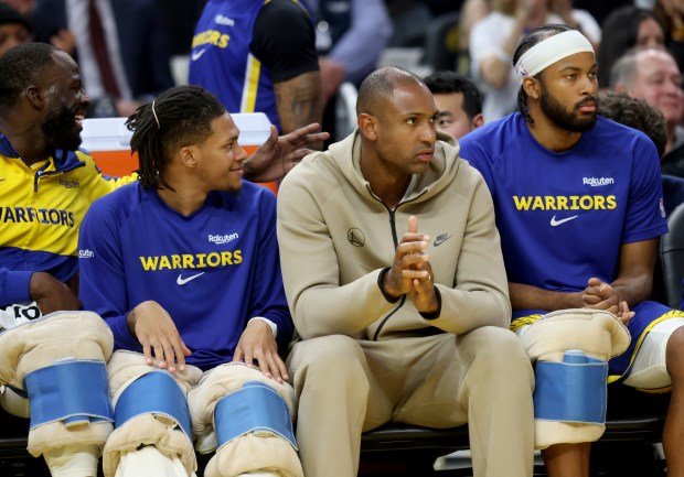 Golden State Warriors' Al Horford #20 watches from the bench...