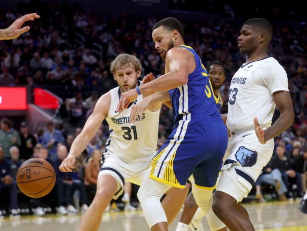 Golden State Warriors' Stephen Curry #30 gets tangled up while guarding Memphis Grizzlies' Jock Landale #31 as the ball goes out of bounds in the third quarter of their NBA game at the Chase Center in San Francisco, Calif., on Monday, Oct. 27, 2025. (Jane Tyska/Bay Area News Group)