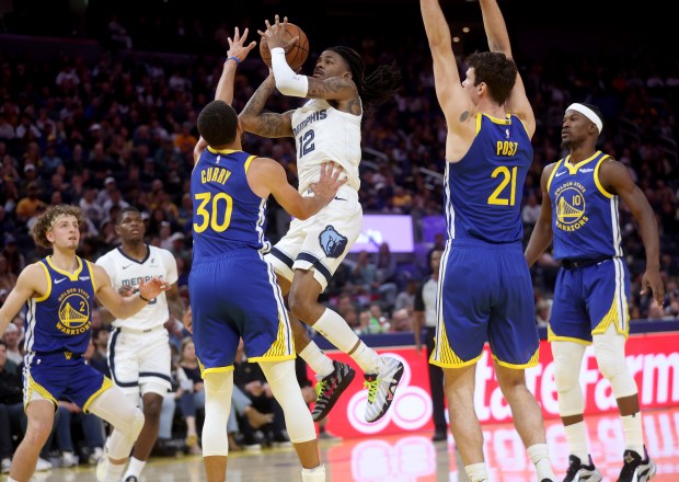 Memphis Grizzlies' Ja Morant #12 shoots past Golden State Warriors'...