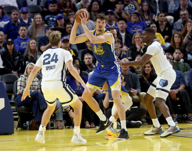 Golden State Warriors' Quinten Post #21 looks to pass as...