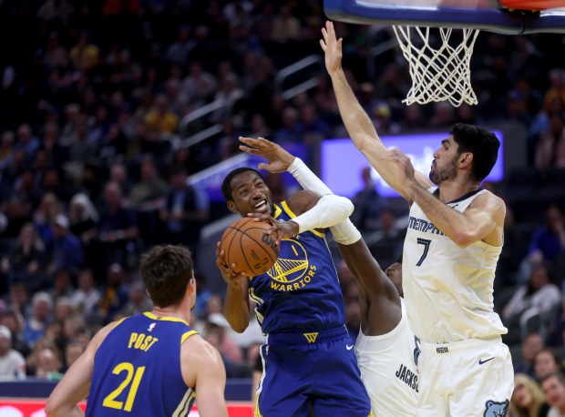Golden State Warriors' Jonathan Kuminga #1 is fouled by Memphis...