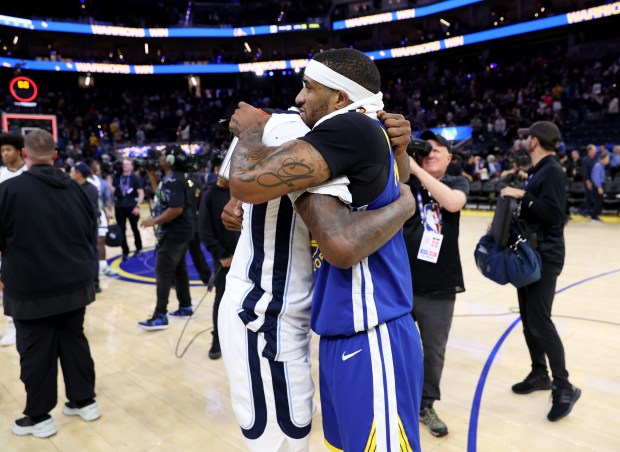 Golden State Warriors' Gary Payton II #0 is congratulated by...
