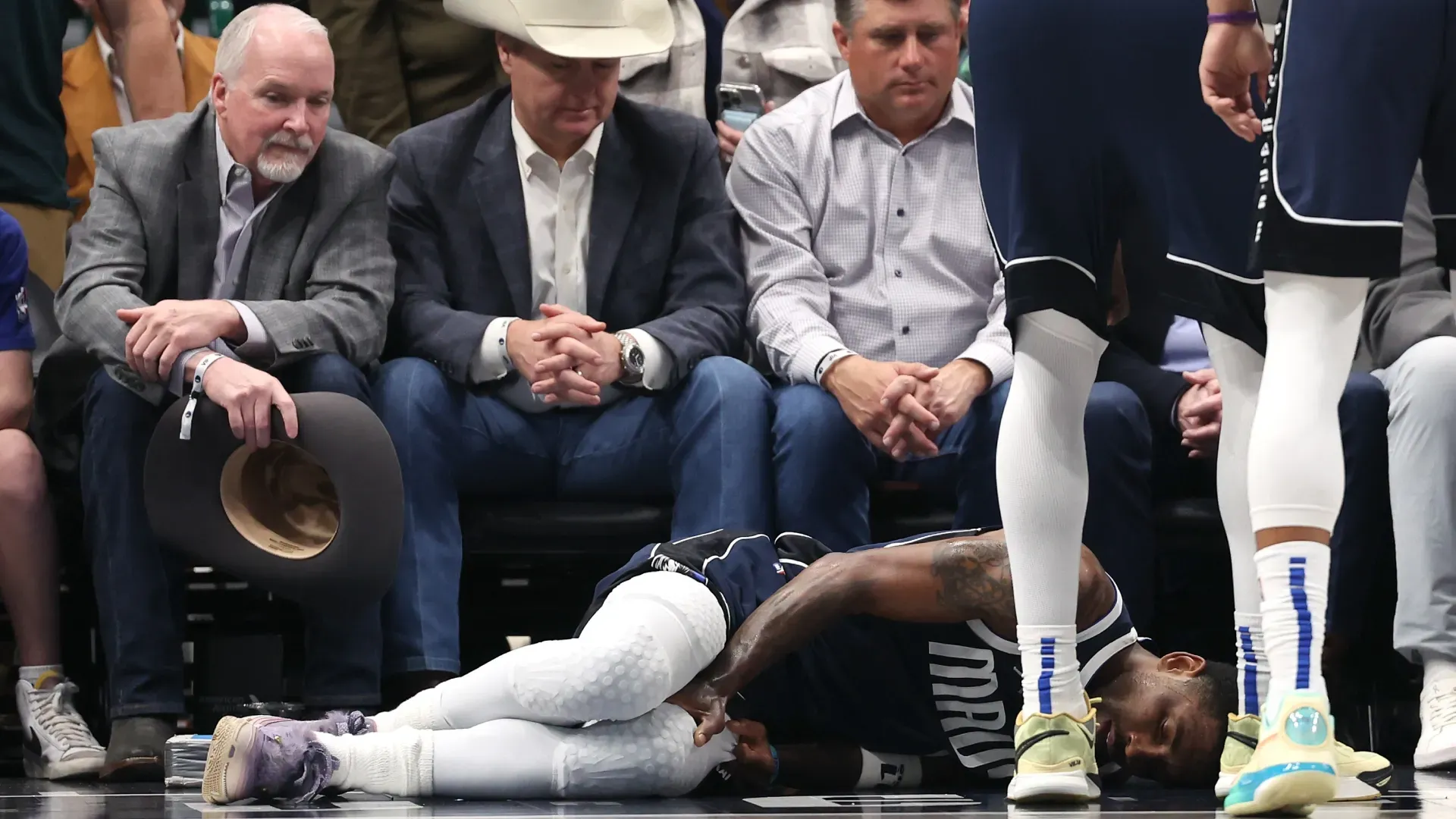 Kyrie Irving of the Dallas Mavericks lies on the court after suffering an injury.