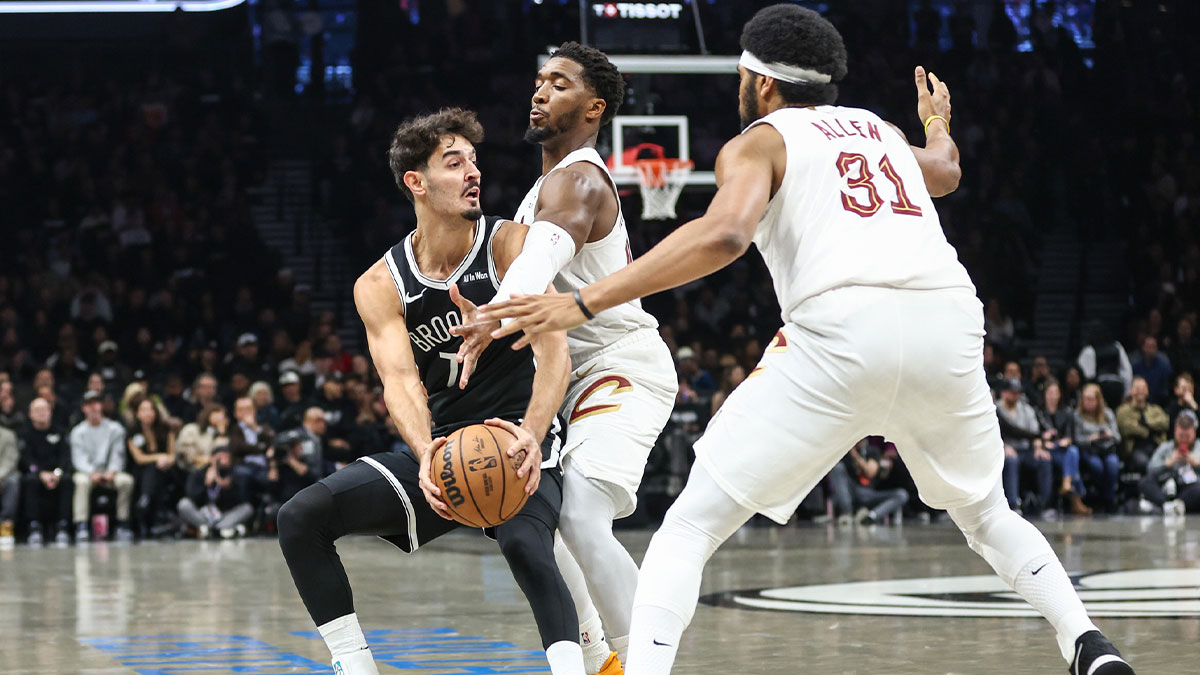 Brooklyn Nets guard Ben Saraf (77) is double teammed by Cleveland Cavaliers guard Donovan Mitchell (45) and center Jarrett Allen (31) in the first quarter at Barclays Center.