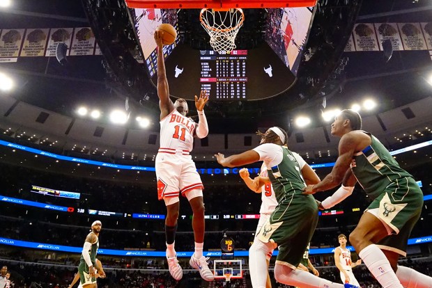 Bulls' Ayo Dosunmu scores against the Bucks' Myles Turner during the second half of a preseason game on Oct. 12, 2025. (AP Photo/David Banks)