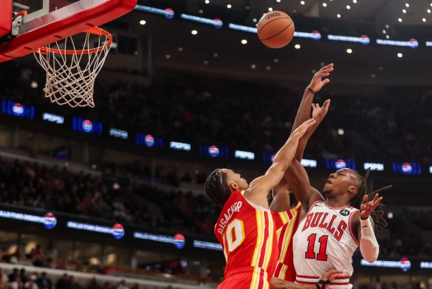 Chicago Bulls guard Ayo Dosunmu (11) goes up for a layup and misses while being contested by Atlanta Hawks forward Zaccharie Risacher (10) during the first half, Monday, Oct. 27, 2025, at the United Center in Chicago. (Dominic Di Palermo/Chicago Tribune)