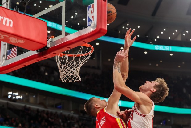 Chicago Bulls forward Matas Buzelis (14) makes a basket while being fouled by Atlanta Hawks' Kristaps Porziņģis (8) in the second quarter, Monday, Oct. 27, 2025, at the United Center in Chicago. (Dominic Di Palermo/Chicago Tribune)