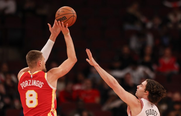 Atlanta Hawks' Kristaps Porziņģis (8) shoots the ball while Chicago Bulls guard Josh Giddey (3) attempts to block him in the first quarter during a game, Monday, Oct. 27, 2025, at the United Center in Chicago. (Dominic Di Palermo/Chicago Tribune)