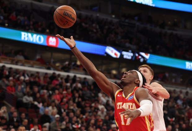Atlanta Hawks' Onyeka Okongwu (17) gets fouled by Chicago Bulls' Kevin Huerter (13) in the third quarter during a game, Monday, Oct. 27, 2025, at the United Center in Chicago. (Dominic Di Palermo/Chicago Tribune)