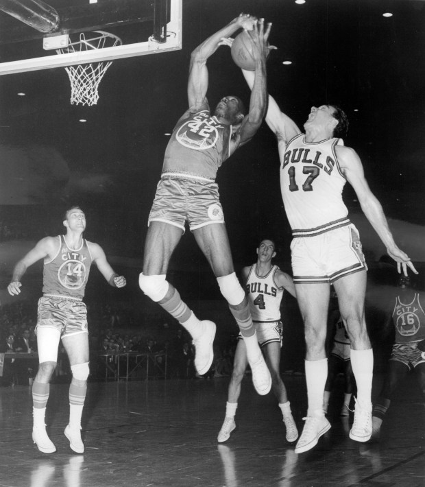 Len Chappell (17) of the Chicago Bulls tips away a rebound from San Francisco's Nate Thurmond (42) as Tom Meschery (14) and Jerry Sloan (4) watch during the Bulls' home opener on Oct. 18, 1966 at the International Amphitheatre in Chicago. (Chicago Tribune historical photo)