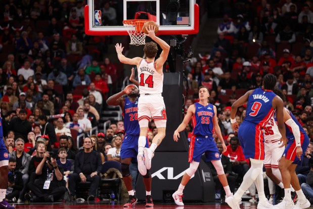 Chicago Bulls forward Matas Buzelis (14) dunks the ball over Detroit Pistons forward Isaiah Stewart (28) during the fourth quarter of the home opener at the United Center Wednesday Oct. 22, 2025 in Chicago. (Armando L. Sanchez/Chicago Tribune)