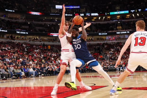 Minnesota Timberwolves forward Julius Randle (30) drives into Chicago Bulls guard Josh Giddey (3) during the first quarter at the United Center Thursday Oct. 16, 2025, in Chicago. (Armando L. Sanchez/Chicago Tribune)
