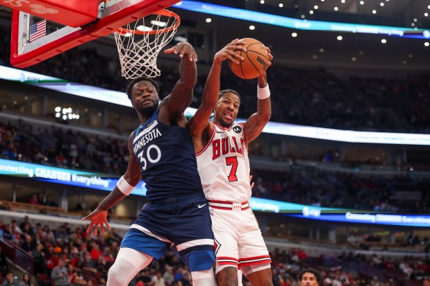 Chicago Bulls forward Dalen Terry (7) grabs a rebound past Minnesota Timberwolves forward Julius Randle (30) during the first quarter at the United Center Thursday Oct. 16, 2025, in Chicago. (Armando L. Sanchez/Chicago Tribune)