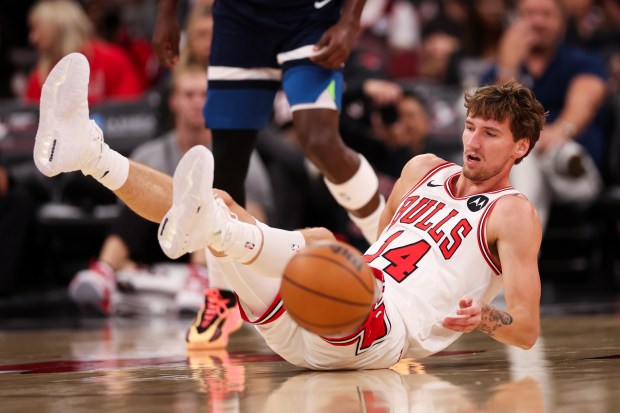 Chicago Bulls forward Matas Buzelis (14) falls on the court during the first quarter against the Minnesota Timberwolves at the United Center Thursday Oct. 16, 2025, in Chicago. (Armando L. Sanchez/Chicago Tribune)