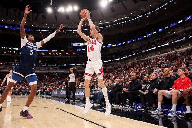 Minnesota Timberwolves forward Jaden McDaniels (3) guards Chicago Bulls forward Matas Buzelis (14) while he tries to make a shot during the third quarter at the United Center Thursday Oct. 16, 2025, in Chicago. (Armando L. Sanchez/Chicago Tribune)