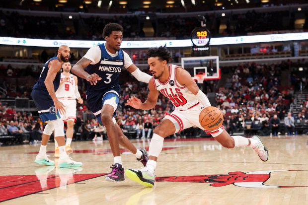 Chicago Bulls guard Tre Jones (30) drives against Minnesota Timberwolves forward Jaden McDaniels (3) during the third quarter at the United Center Thursday Oct. 16, 2025, in Chicago. (Armando L. Sanchez/Chicago Tribune)