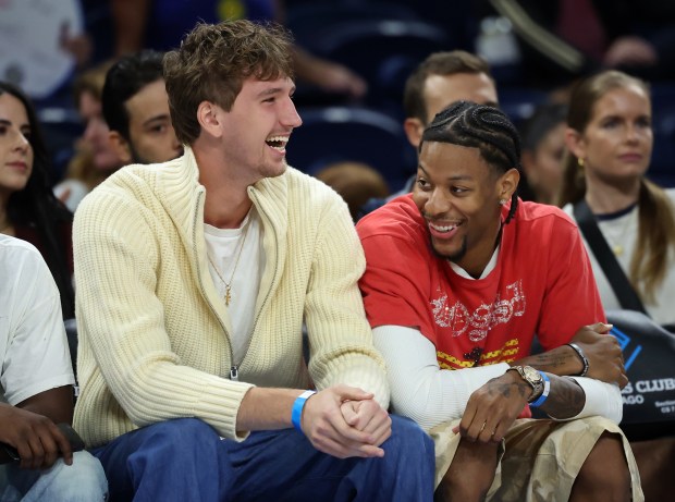 Bulls players Matas Buzelis, left, and Dalen Terry have a laugh while taking in a game between the Chicago Sky and Connecticut Sun on Sept. 3, 2025, at Wintrust Arena. (Chris Sweda/Chicago Tribune)