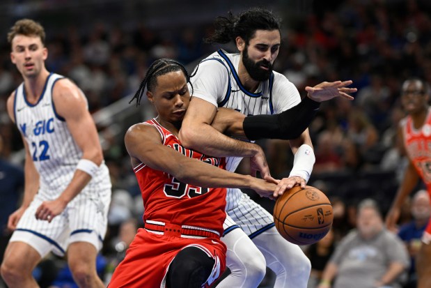 Bulls forward Isaac Okoro and Magic center Goga Bitadze, right, battle for the ball during the first half Saturday, Oct. 25, 2025, in Orlando, Fla. (Phelan M. Ebenhack/AP)
