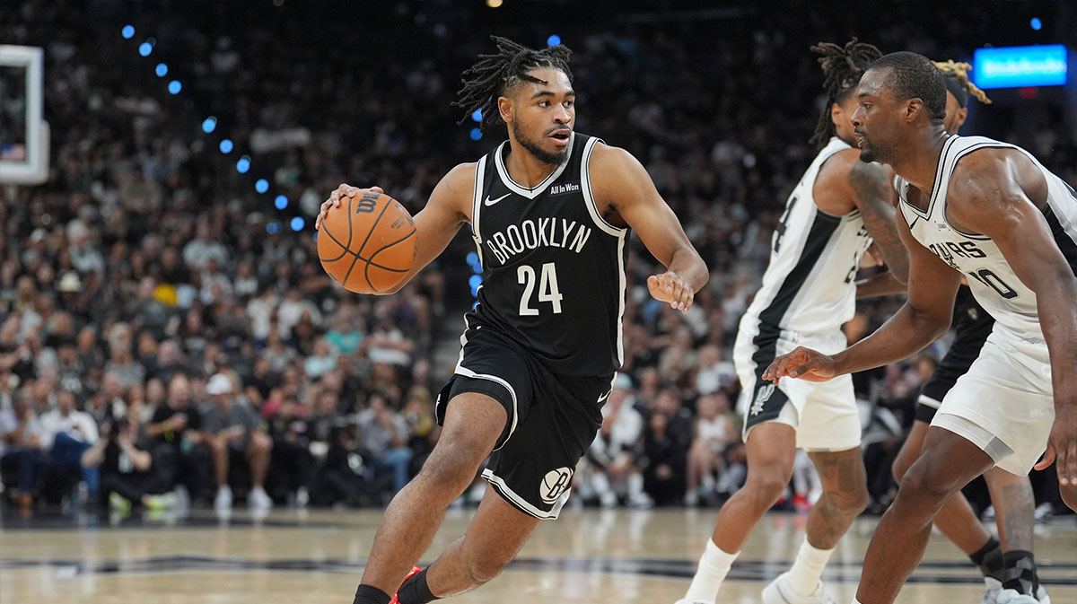 Brooklyn Nets guard Cam Thomas (24) dribbles against San Antonio Spurs forward Harrison Barnes (40) in the first half at Frost Bank Center.