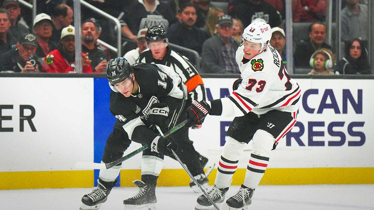LA Kings right wing Alex Laferriere (14) and Chicago Blackhawks left wing Lukas Reichel (73) battle for the puck.