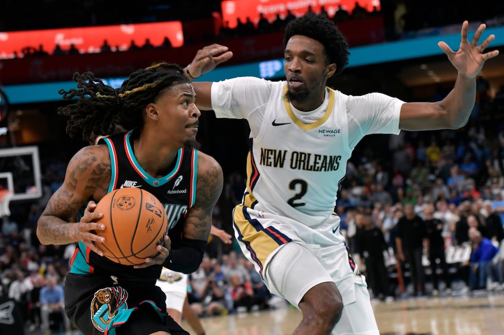 Memphis Grizzlies guard Ja Morant drives against New Orleans Pelicans forward Herbert Jones...