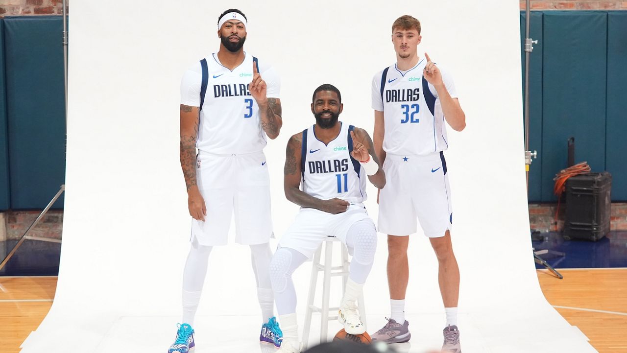 Dallas Mavericks forward Cooper Flagg (32), guard Kyrie Irving (11) and forward Anthony Davis (3) pose for a photo during the NBA basketball team's media day in Dallas, Monday, Sept. 29, 2025. (AP Photo/LM Otero)