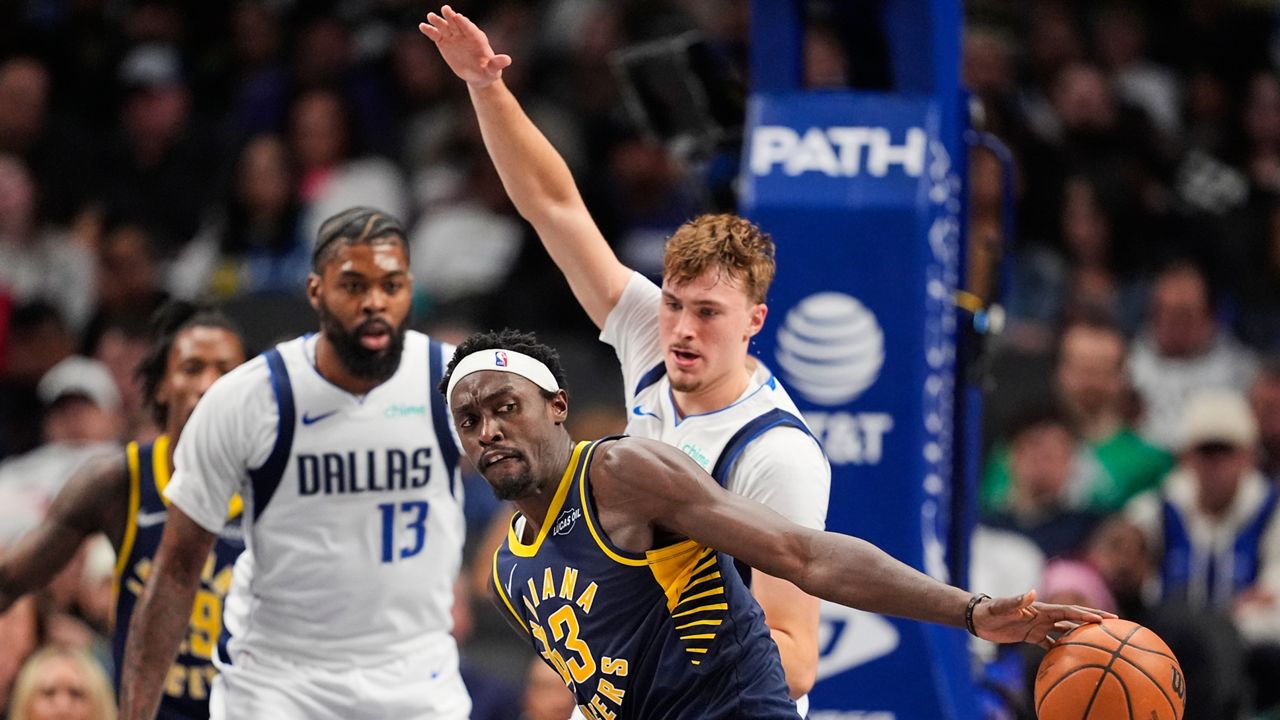 Indiana Pacers forward Pascal Siakam (43) loses control of the ball as Dallas Mavericks' Cooper Flagg defends in the second half of an NBA basketball game Wednesday, Oct. 29, 2025, in Dallas. (AP Photo/Tony Gutierrez)