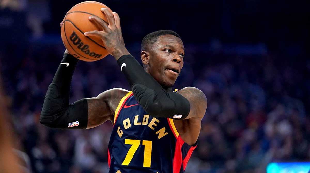 Golden State Warriors guard Dennis Schroder (71) holds onto a rebound against the Phoenix Suns in the first quarter at the Chase Center.