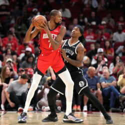 Houston Rockets forward Kevin Durant (7) controls the ball against Brooklyn Nets guard Terance Mann, right, during the first half of an NBA basketball game, Monday, Oct. 27, 2025, in Houston. (AP Photo/Karen Warren)