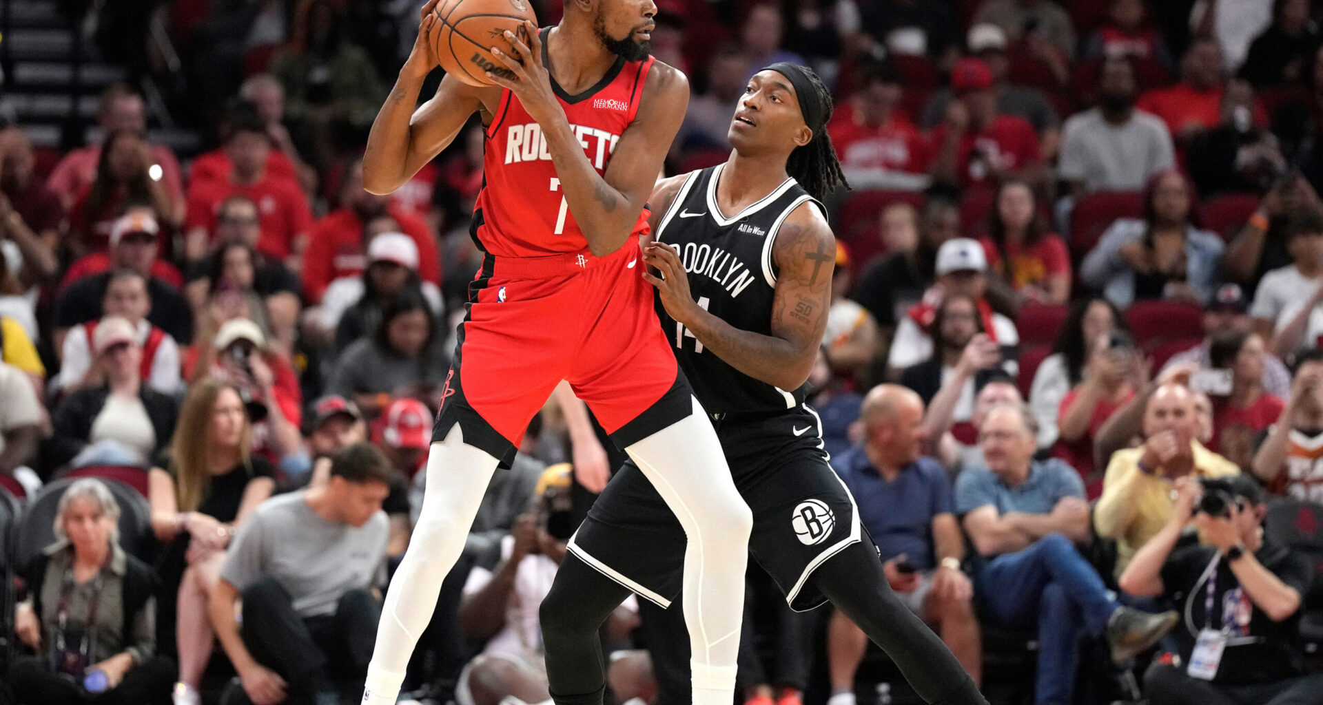 Houston Rockets forward Kevin Durant (7) controls the ball against Brooklyn Nets guard Terance Mann, right, during the first half of an NBA basketball game, Monday, Oct. 27, 2025, in Houston. (AP Photo/Karen Warren)